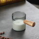 Milk frothing pitcher with wooden handle